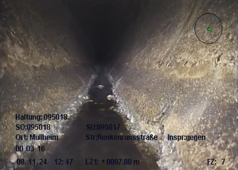 View of the storm sewer with inspection markings and overlaid survey data.