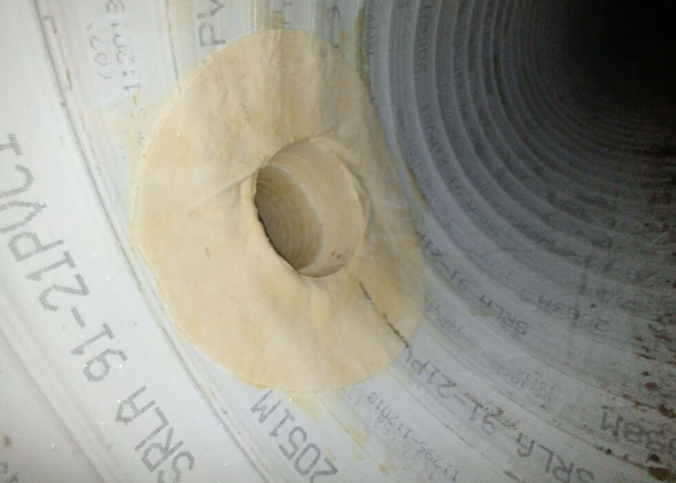 Close-up view of the inside of the pipe showing a circular opening for a branch line